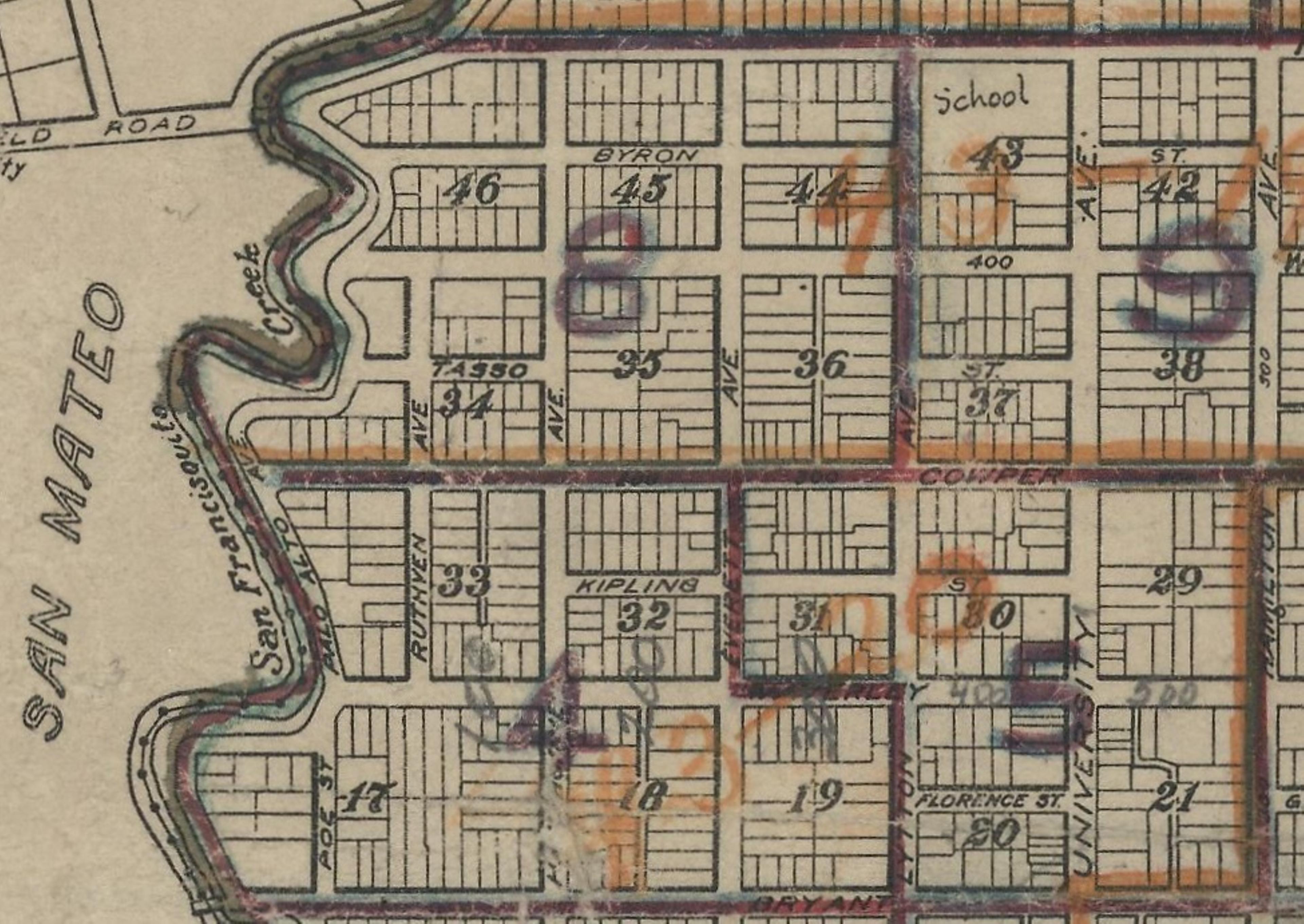 A close-up grid of streets with red and orange pencil lines dividing the grid into numbered districts